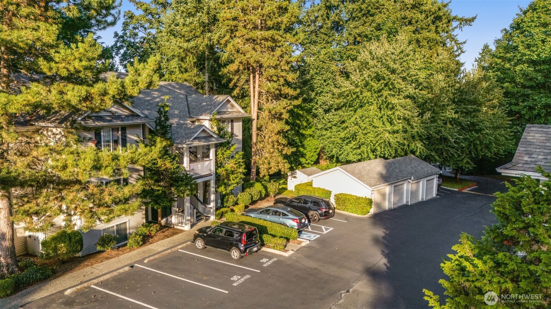 12120 Northeast 172nd Place, Unit L201 Bothell, WA 98011 - Photo 24 of 35 an aerial view of a house with swimming pool and large trees