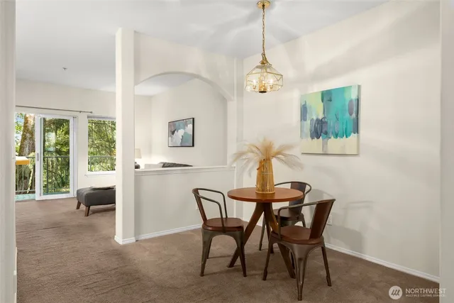 a view of a dining room with furniture and a chandelier