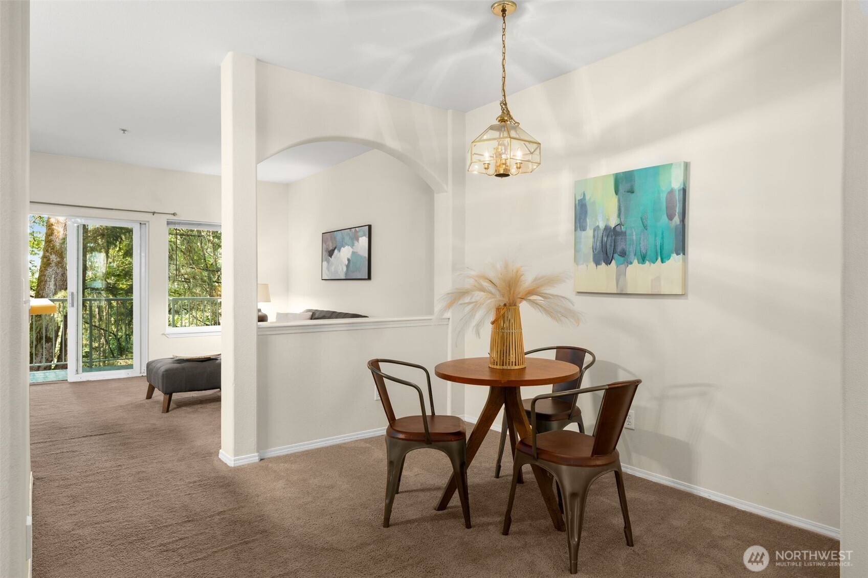 12120 Northeast 172nd Place, Unit L201 Bothell, WA 98011 - Photo 3 of 35 a view of a dining room with furniture and a chandelier