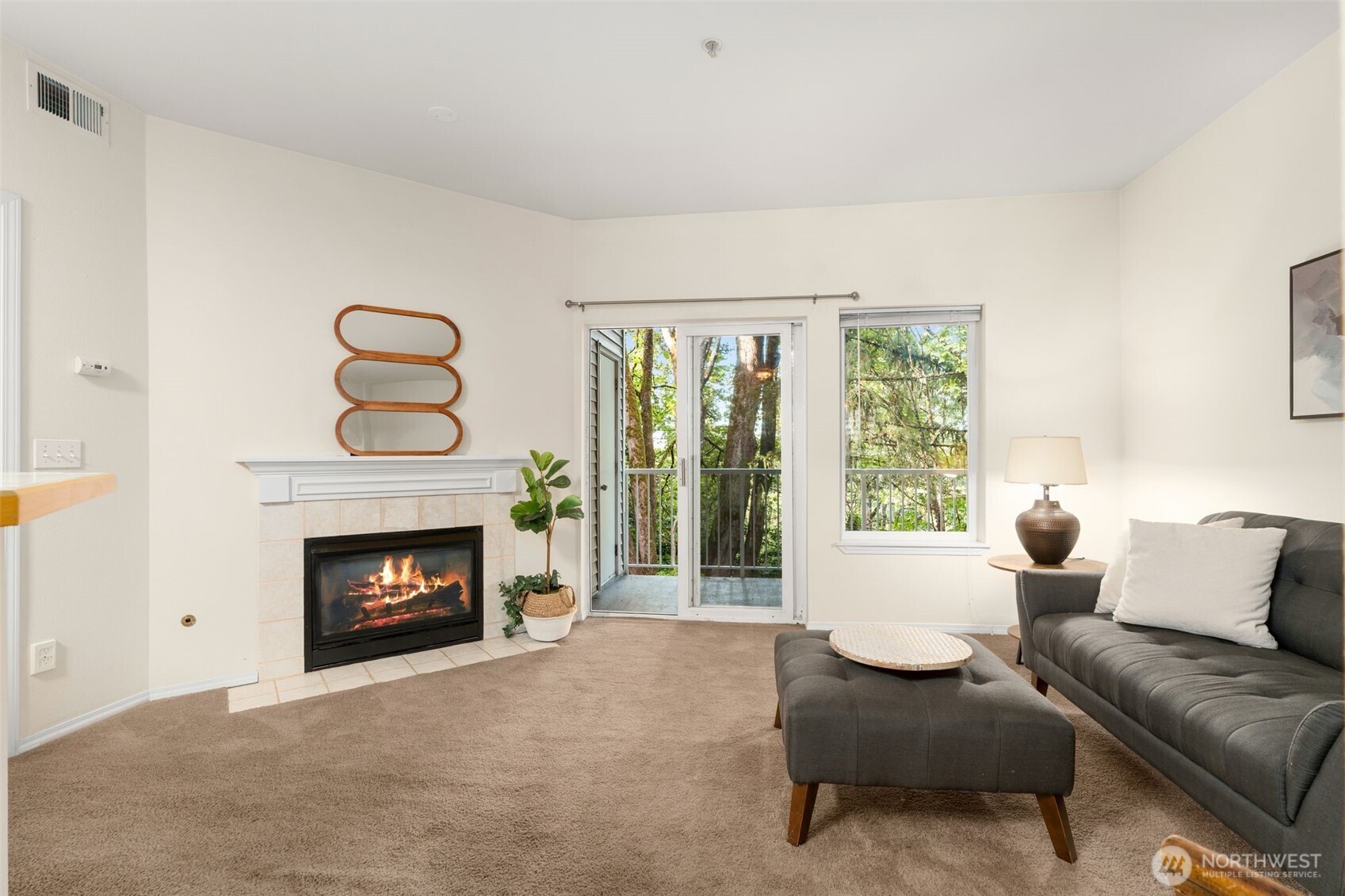 12120 Northeast 172nd Place, Unit L201 Bothell, WA 98011 - Photo 5 of 35 a living room with furniture and a fireplace