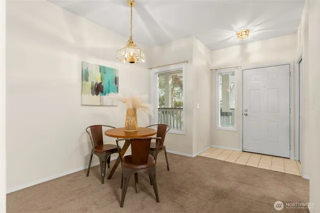 a view of a dining room with furniture and chandelier