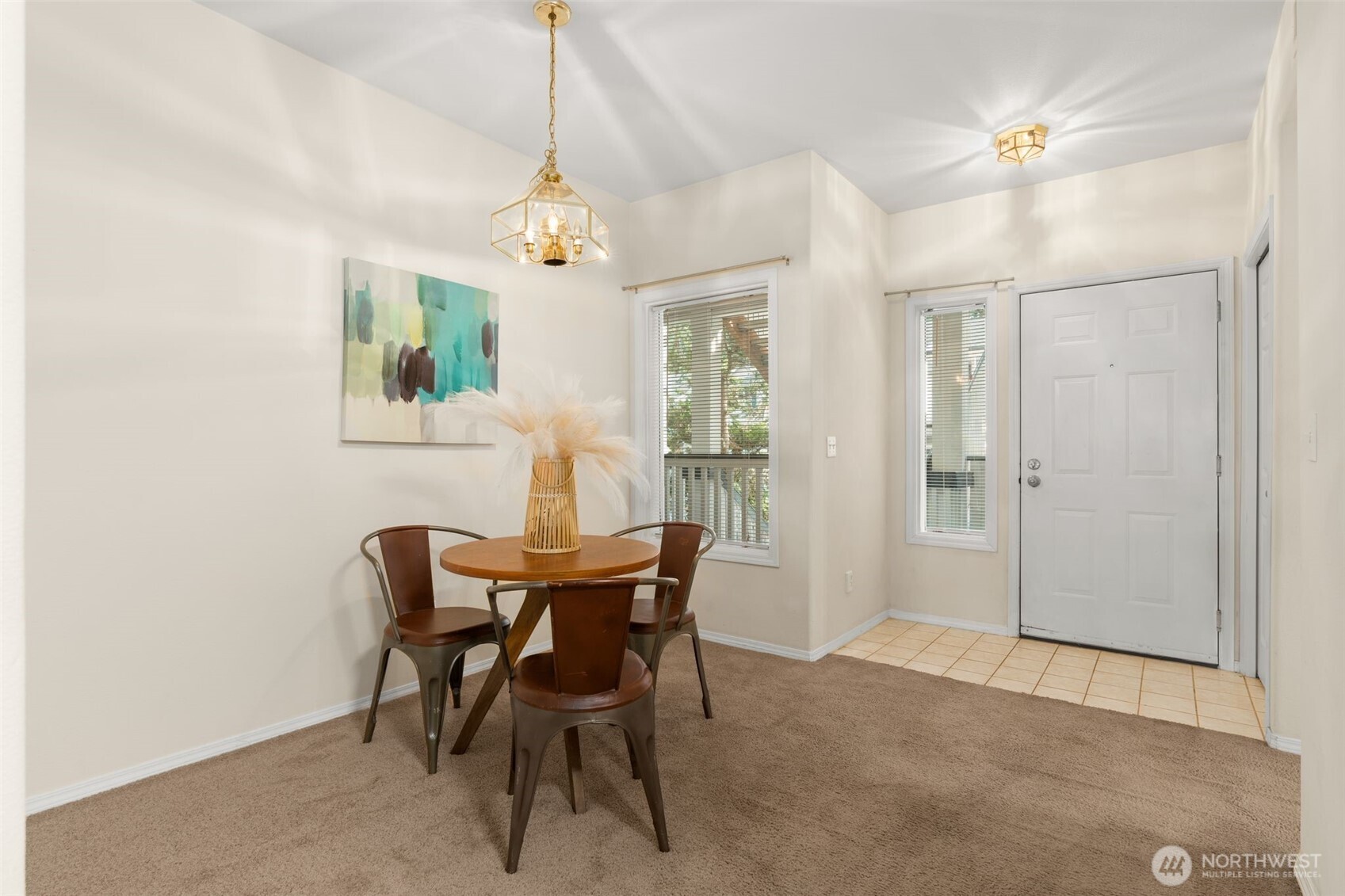 12120 Northeast 172nd Place, Unit L201 Bothell, WA 98011 - Photo 7 of 35 a view of a dining room with furniture and chandelier
