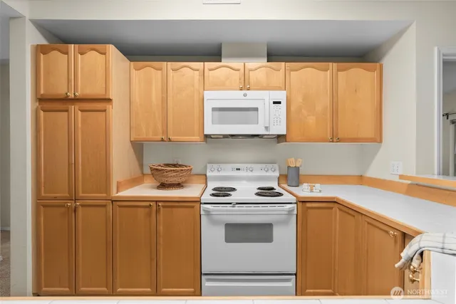 a kitchen with stainless steel appliances granite countertop a refrigerator sink and stove