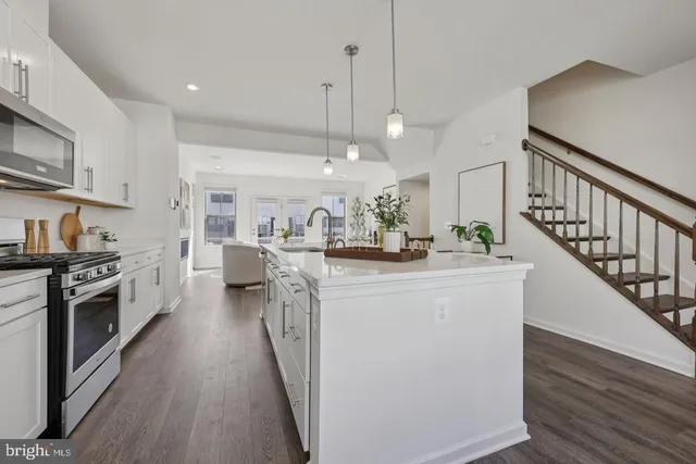 a kitchen with sink a stove and cabinets