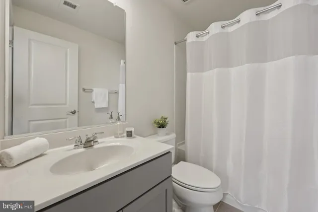 a white toilet sitting next to a white sink
