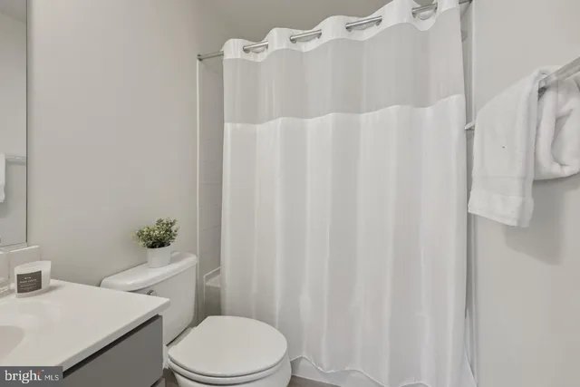 a bathroom with a sink toilet and a mirror