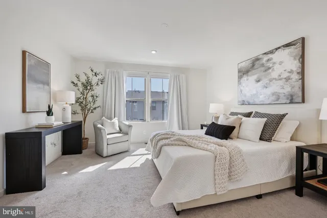 a bedroom with a bed and a painting on the wall