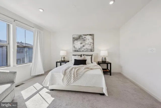 a bathroom with a toilet a sink a mirror a shower and vanity