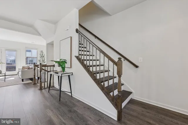 a view of entryway with wooden floor and stairs