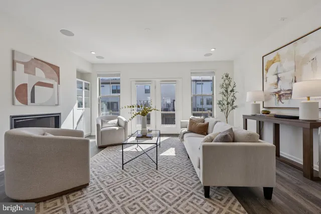 a living room with fireplace furniture and a rug