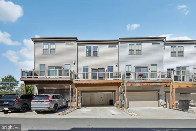 a picture of a bench in front of a white house