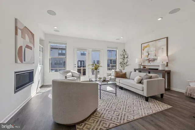 a living room with fireplace furniture and a wooden floor