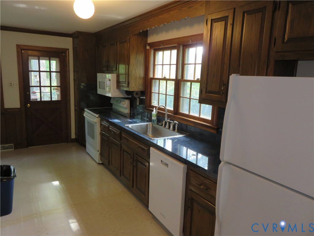 8379 Quailfield Road Mechanicsville, VA 23116 - Photo 21 of 56 a kitchen with stainless steel appliances granite countertop a refrigerator a sink a stove and a refrigerator