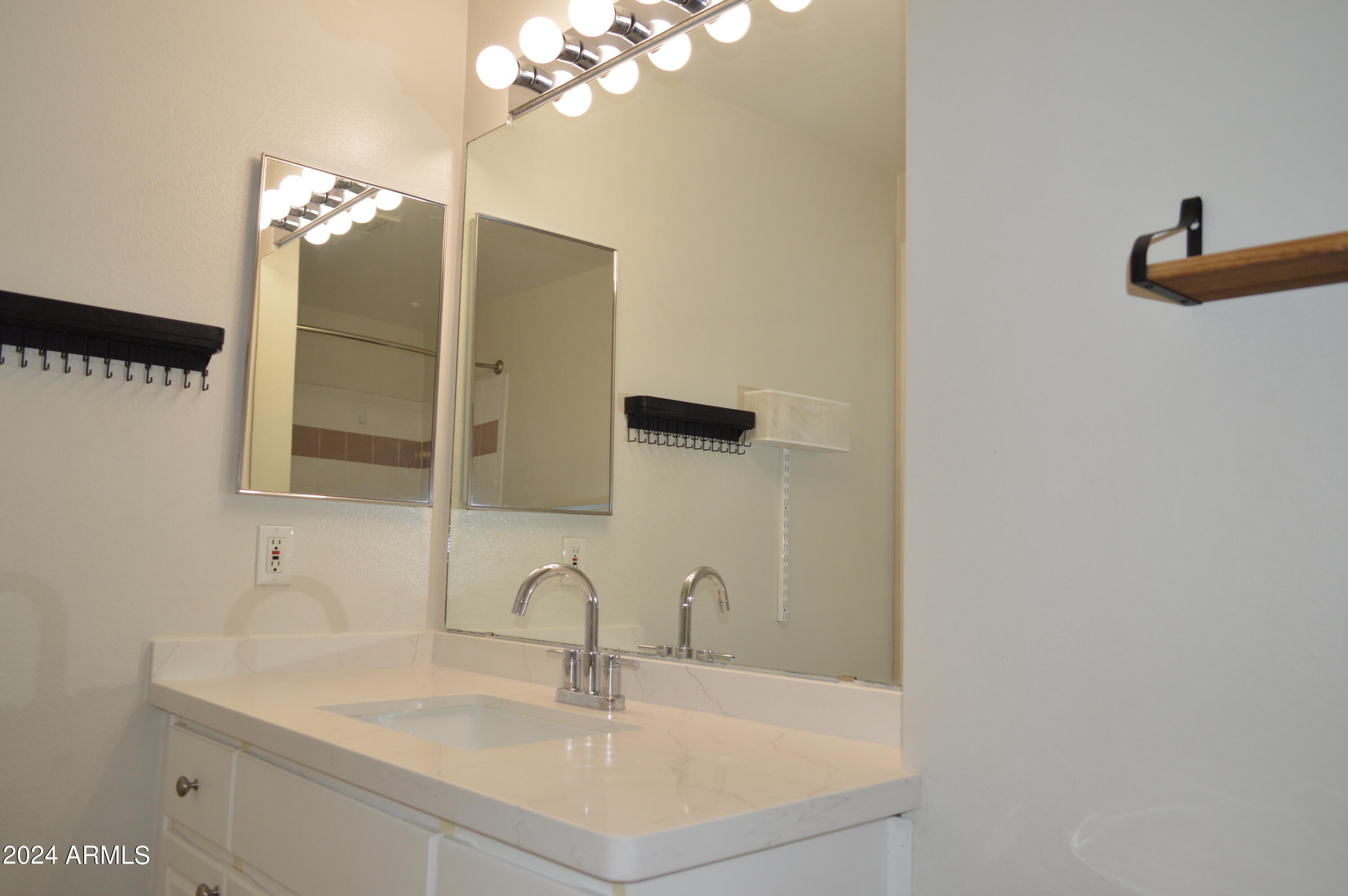 1701 East Colter Street, Unit 263 Phoenix, AZ 85016 - Photo 16 of 65 a bathroom with a sink and a mirror