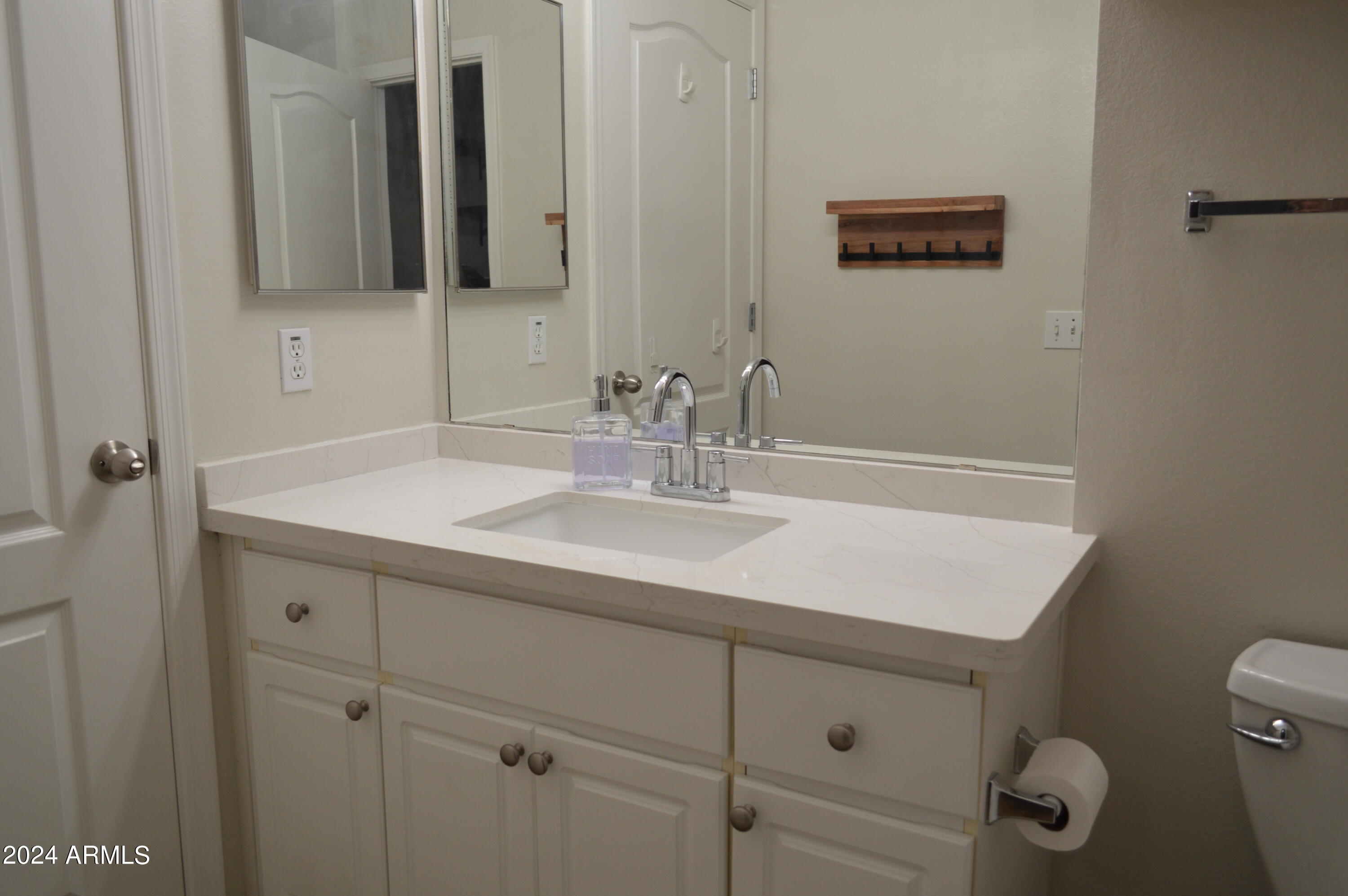 1701 East Colter Street, Unit 263 Phoenix, AZ 85016 - Photo 17 of 65 a bathroom with a sink and a mirror