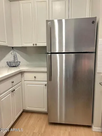 a view of storage and utility room with wooden floor