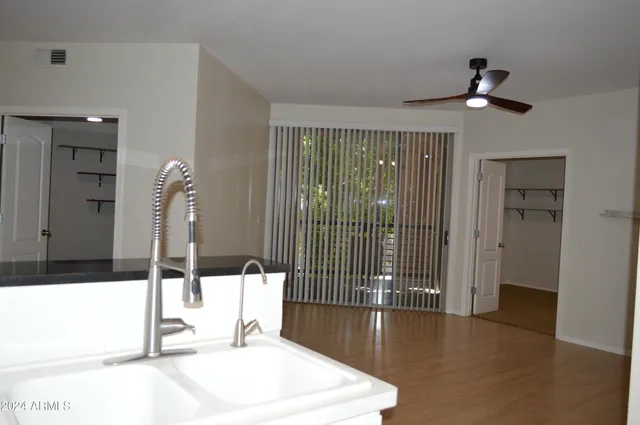 a view of a refrigerator in kitchen and a sink