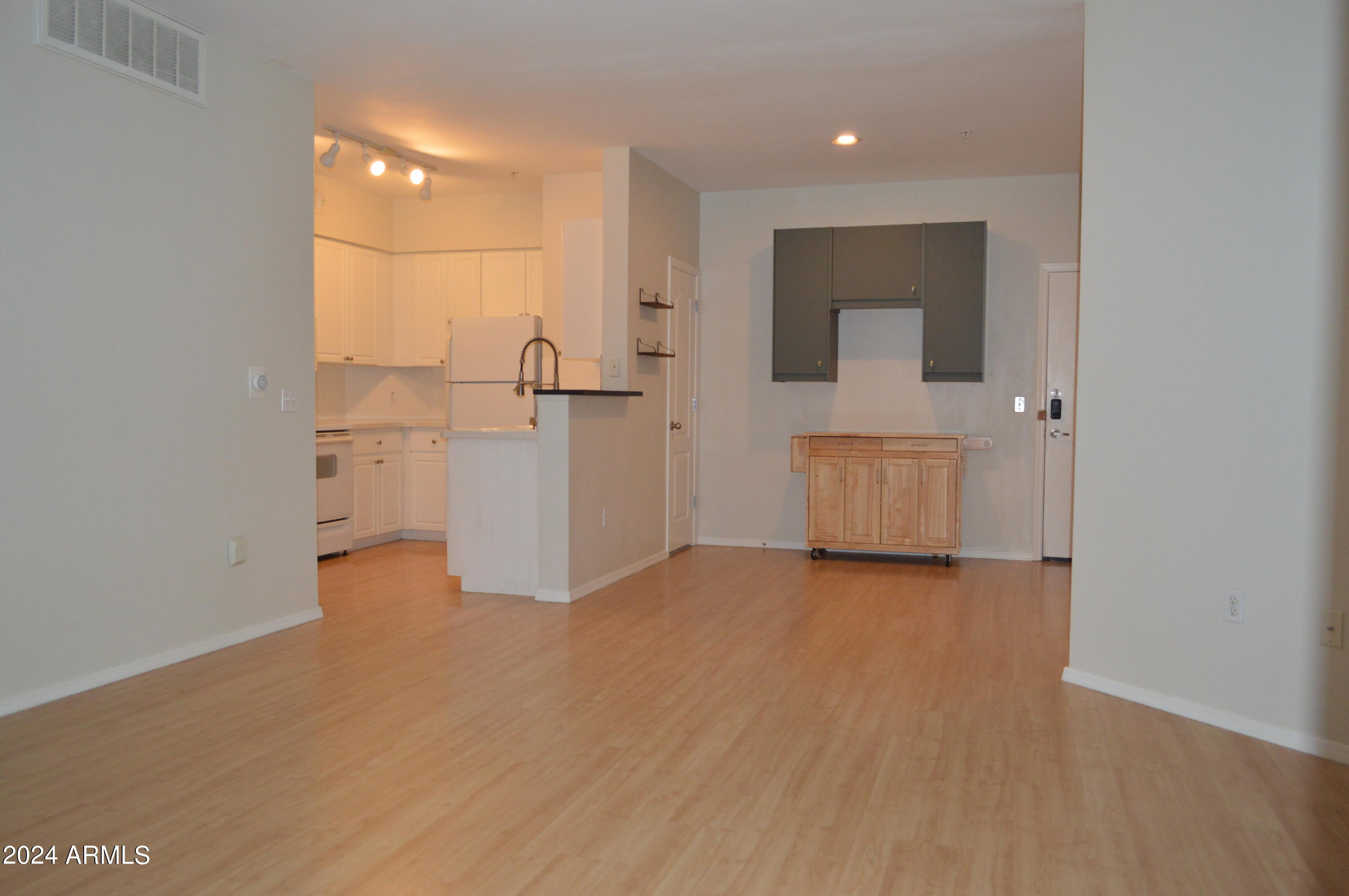 1701 East Colter Street, Unit 263 Phoenix, AZ 85016 - Photo 8 of 65 a view of an empty room with a kitchen
