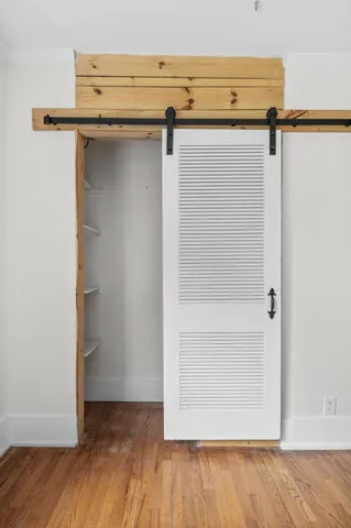 a view of walk in closet with empty racks