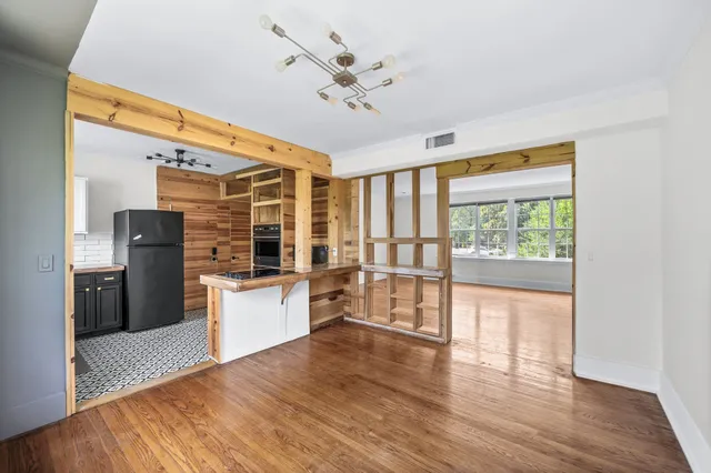 a kitchen with granite countertop wooden floors and wide window