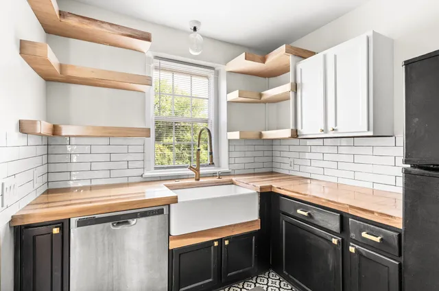 a kitchen with a sink stove and cabinets