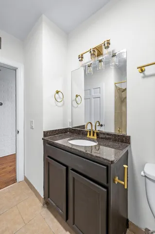a bathroom with a granite countertop sink and a mirror