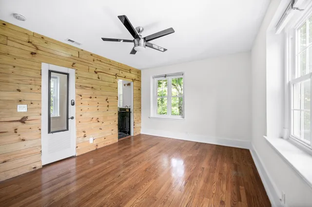 a bathroom with a granite countertop sink a mirror and a shower