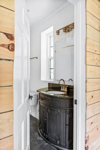 a bathroom with a tub a sink and mirror