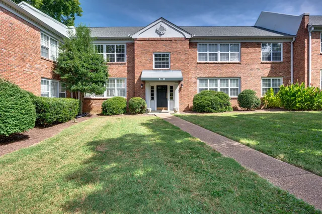 a front view of a house with garden and porch