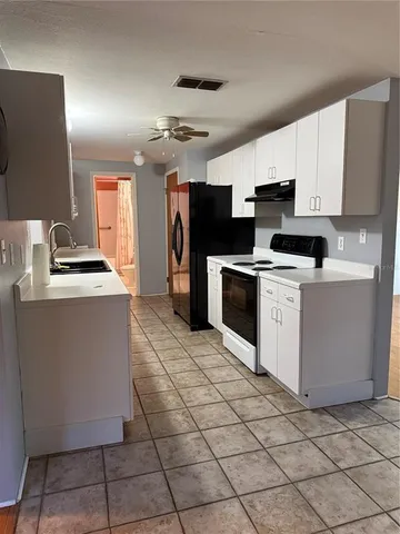 a kitchen with stainless steel appliances granite countertop a stove a sink dishwasher and a refrigerator