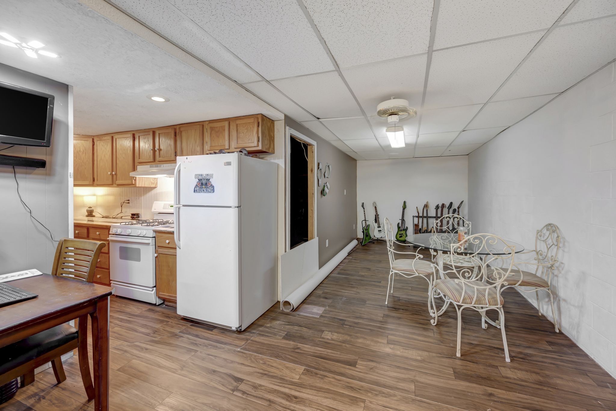 6125 Highway 41 A Pleasant View, TN 37146 - Photo 23 of 32 a kitchen with stainless steel appliances a refrigerator a stove top oven a sink dishwasher a dining table and chairs with wooden floor