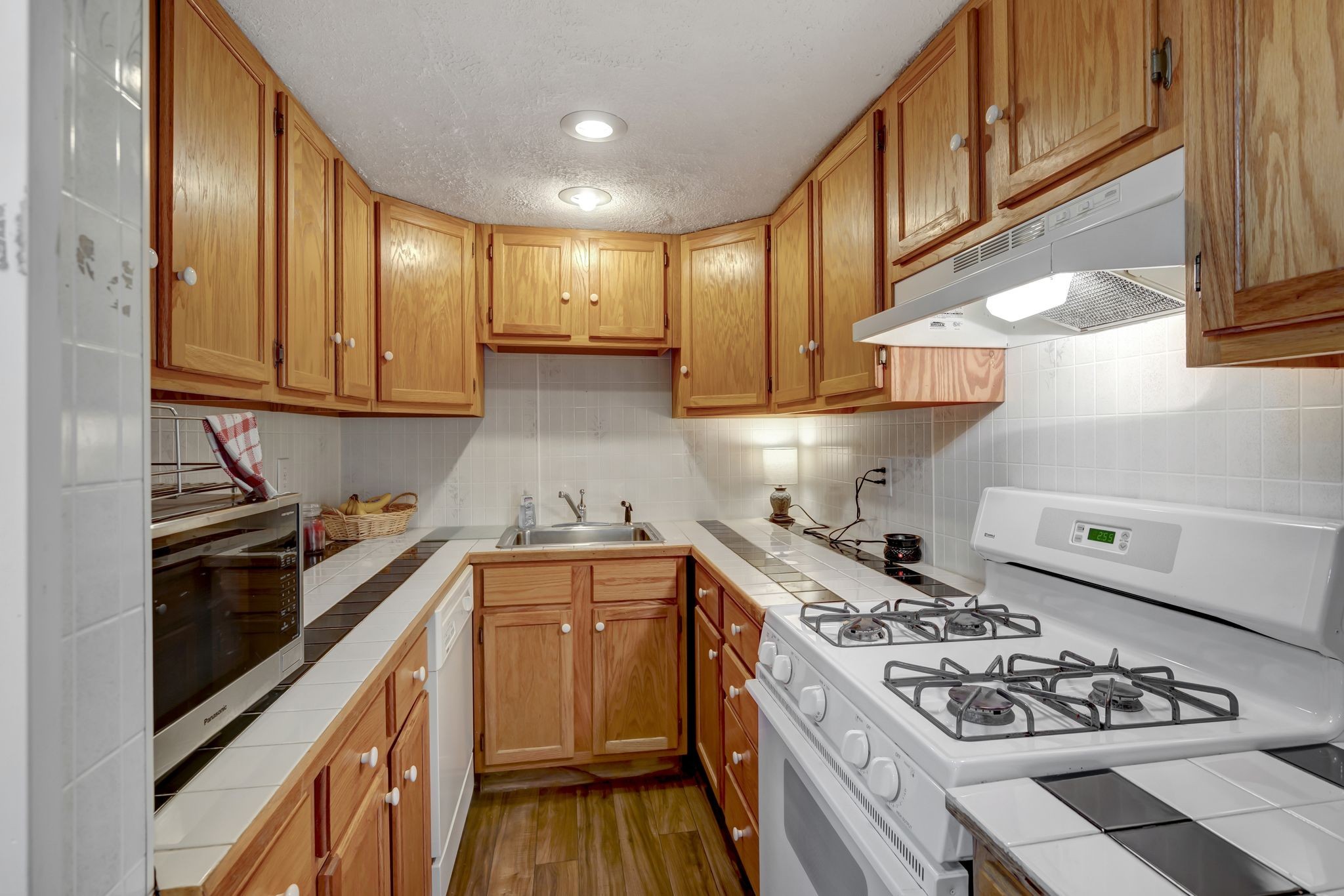6125 Highway 41 A Pleasant View, TN 37146 - Photo 24 of 32 a kitchen with stainless steel appliances a stove a sink dishwasher and cabinets with wooden floor