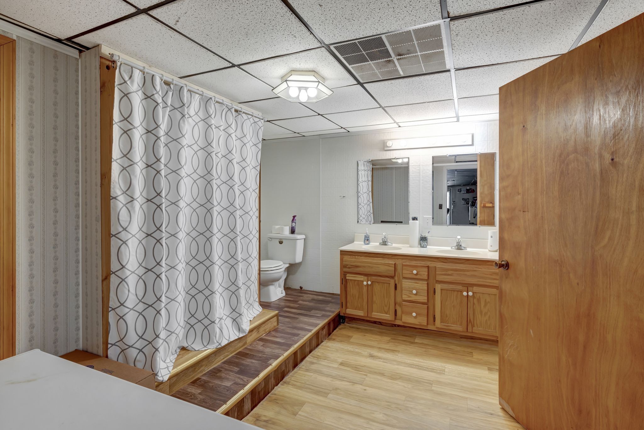 6125 Highway 41 A Pleasant View, TN 37146 - Photo 25 of 32 a bathroom with a granite countertop sink a toilet and shower