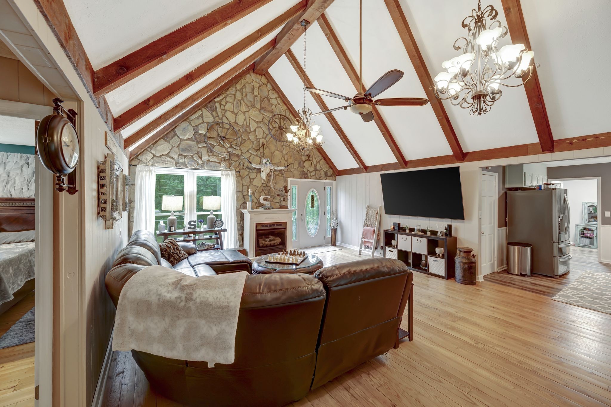 6125 Highway 41 A Pleasant View, TN 37146 - Photo 3 of 32 a living room with furniture a flat screen tv and a floor to ceiling window