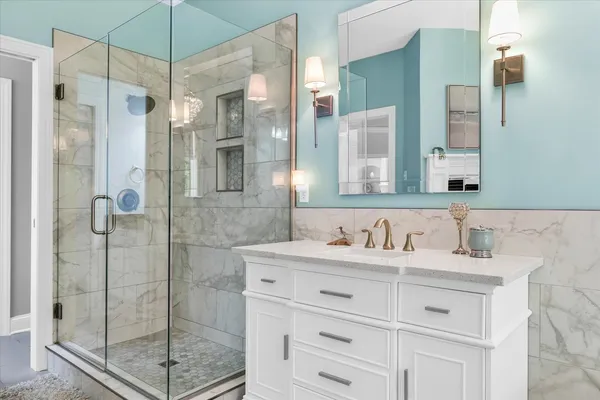 a bathroom with a shower sink and mirror