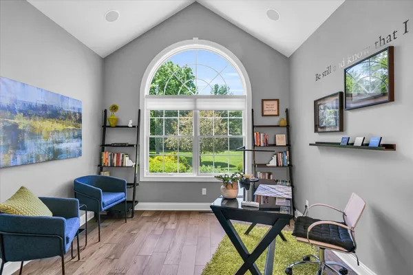 a living room with furniture and a floor to ceiling window