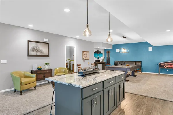 a kitchen with sink and chairs