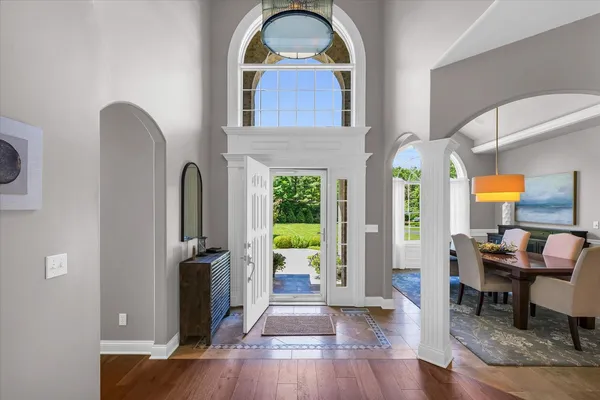 a view of entryway and hall with wooden floor