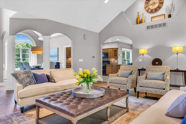a living room with patio furniture and a potted plant