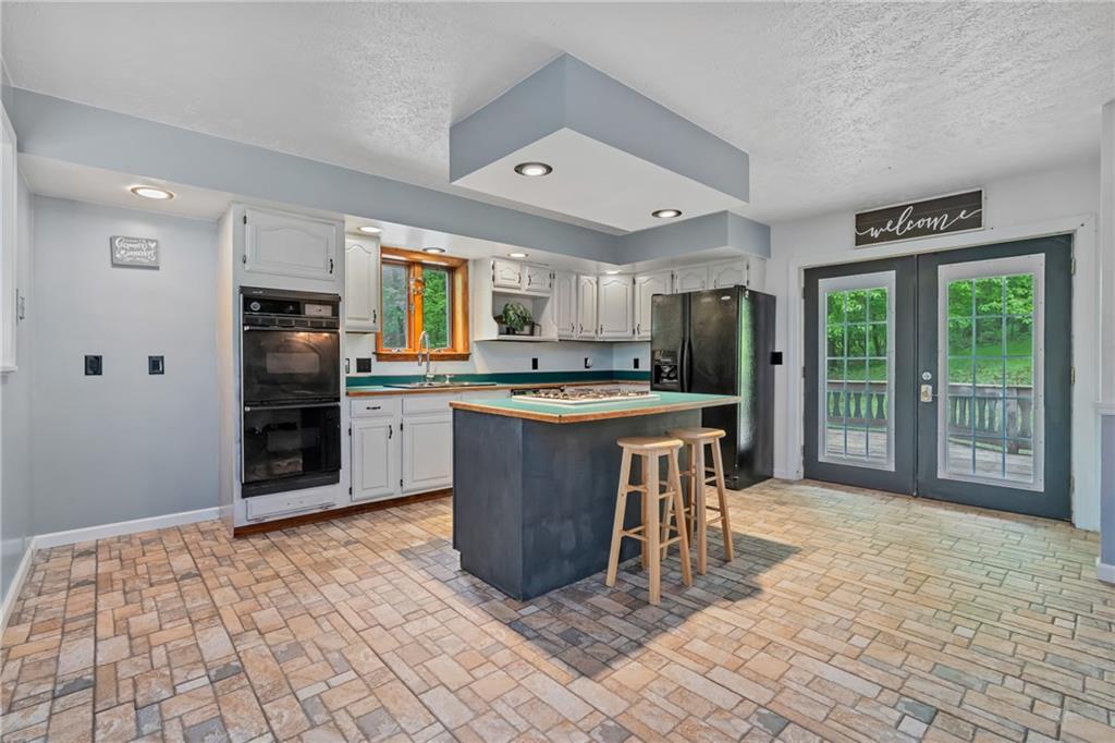 144 Church Road Rural Valley, PA 16249 - Photo 20 of 33 a kitchen with stainless steel appliances granite countertop a stove top oven a sink and a refrigerator