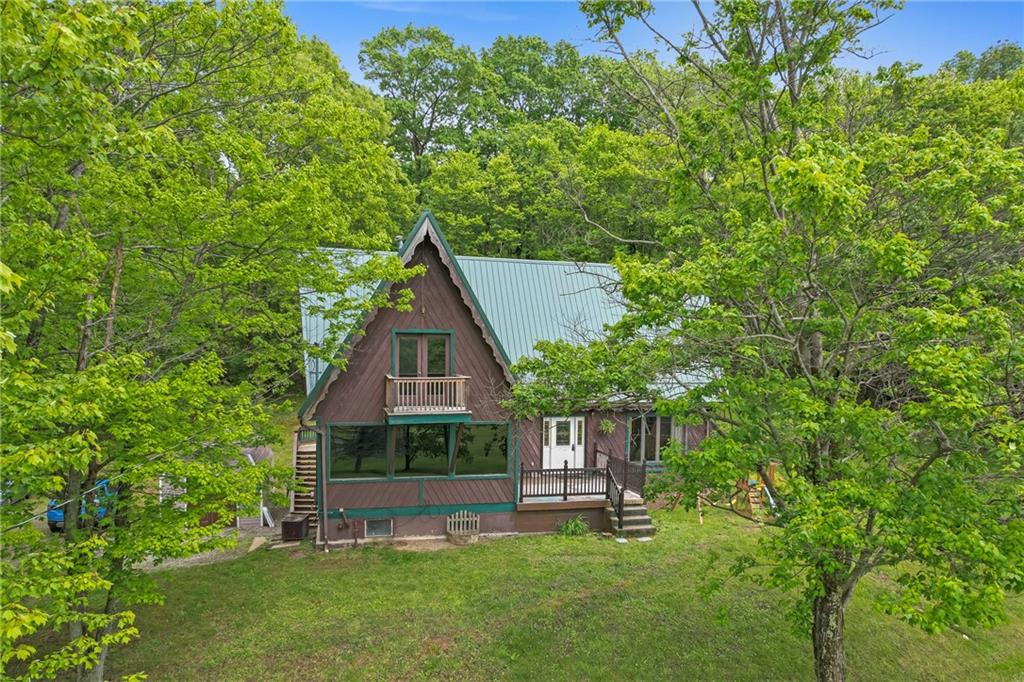 144 Church Road Rural Valley, PA 16249 - Photo 6 of 33 a front view of a house with a garden and sitting area
