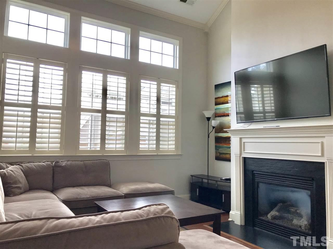 840 Historian Street Raleigh, NC 27603 - Photo 7 of 25 a living room with furniture and a fireplace