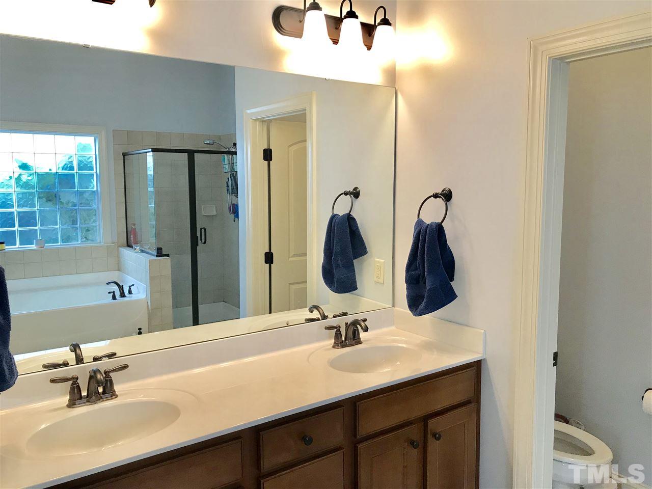 840 Historian Street Raleigh, NC 27603 - Photo 9 of 25 a bathroom with a sink and a mirror