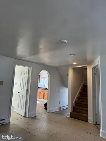 an empty room with windows and entryway