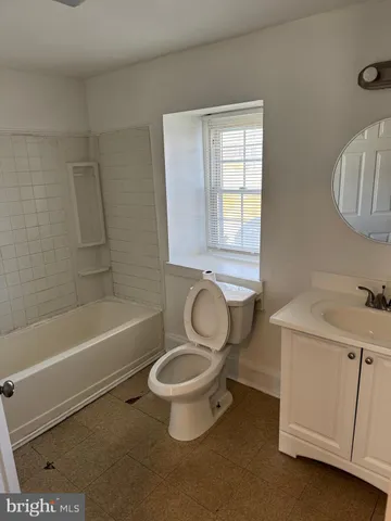 a bathroom with a sink a toilet and a bathtub