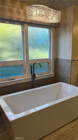 a bath tub sitting in a bathroom next to a window