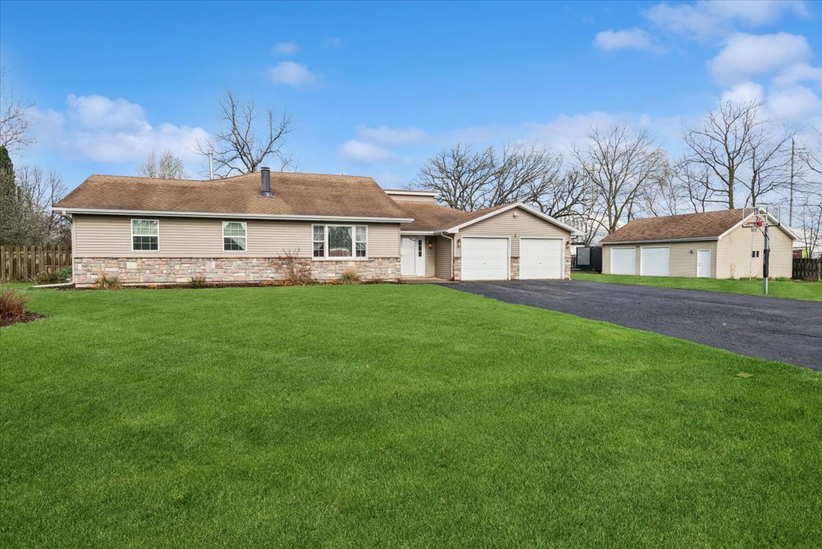 a front view of a house with a yard and trees