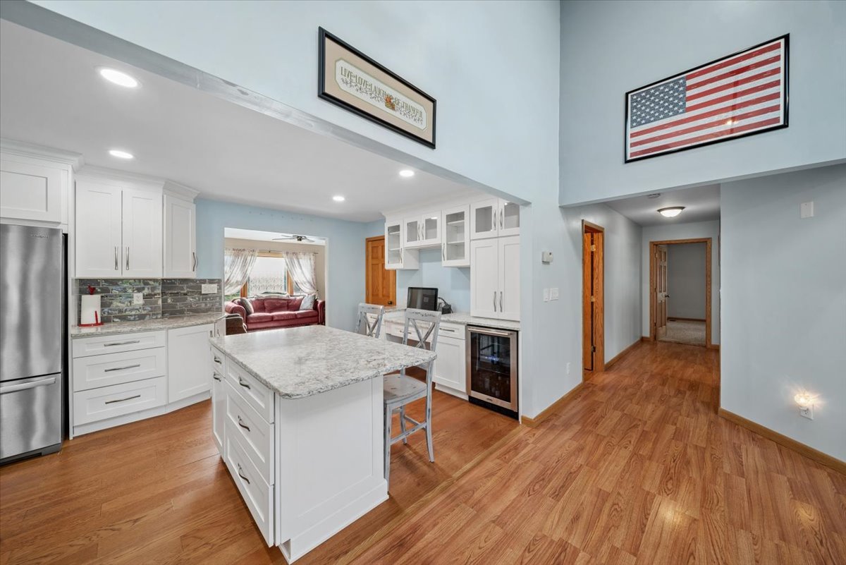 2 Division Street Bristol, IL 60512 - Photo 12 of 44 a kitchen with white cabinets and stainless steel appliances