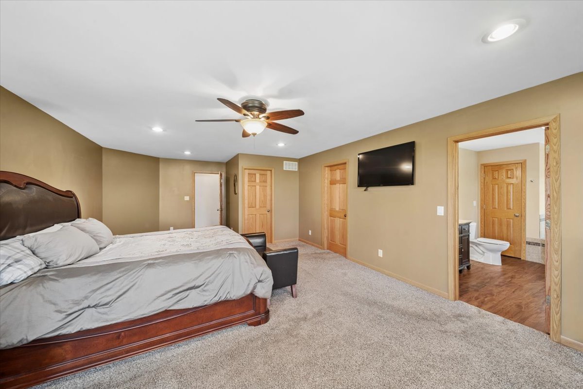 2 Division Street Bristol, IL 60512 - Photo 15 of 44 a bedroom with a bed and a flat screen tv