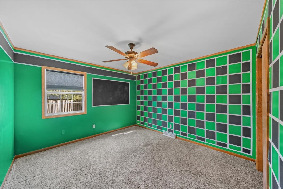 2 Division Street Bristol, IL 60512 - Photo 23 of 44 a view of an empty room with a window and a ceiling fan